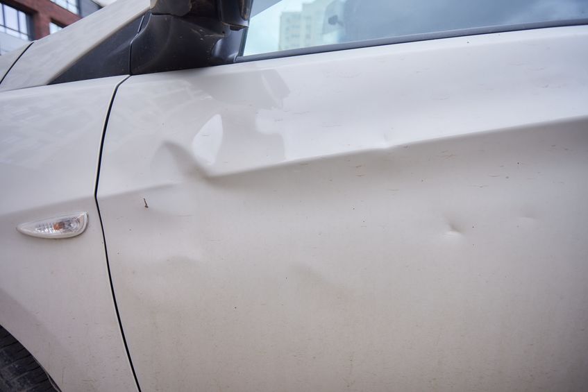 minor car dent on the side of a car near driver door